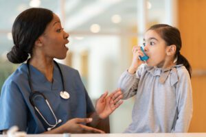 Female doctor with asthma child patient