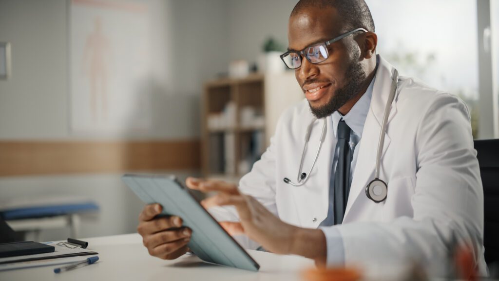 Primary care physician checking reports on Tab