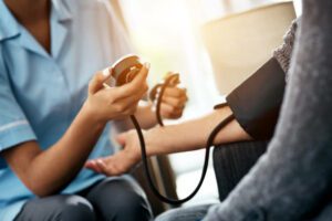 Cropped shot of a senior woman getting her blood pressure measured during a checkup with a nurse