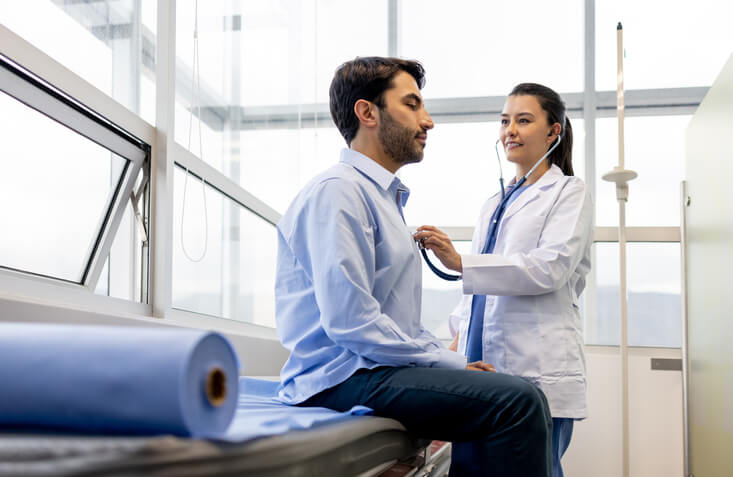 Cardiologist examining a patient at her office