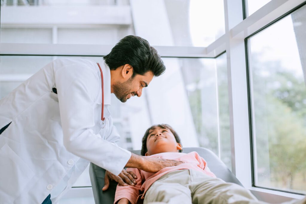 Gastroenterologist examines the patient on the table