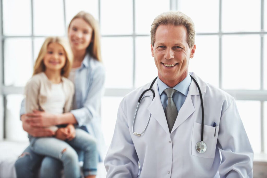 A mother and her daughter are at the office of a primary care doctor and pediatrician.