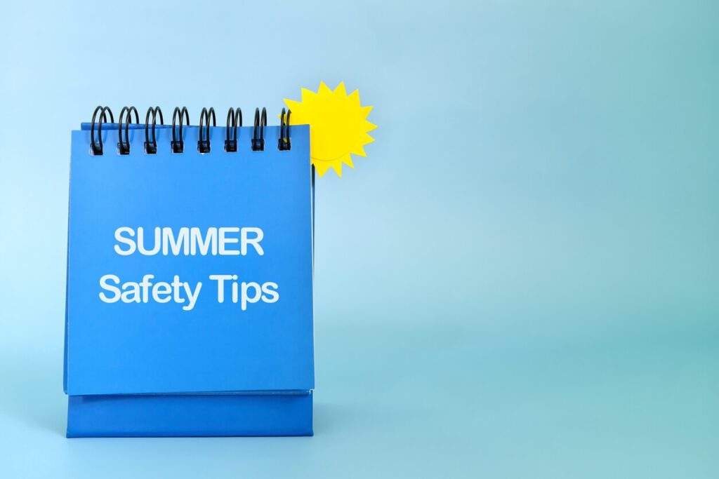 Summer essentials and safety tips reminder concept written on a calendar with a paper sun.