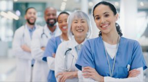 A group of doctors with their arms crossed stands in a hospital, ready to provide healthcare services.