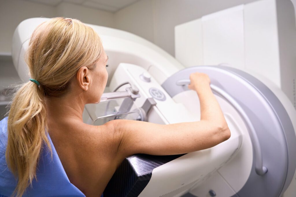 An adult female patient receiving 3D mammography in clinic.