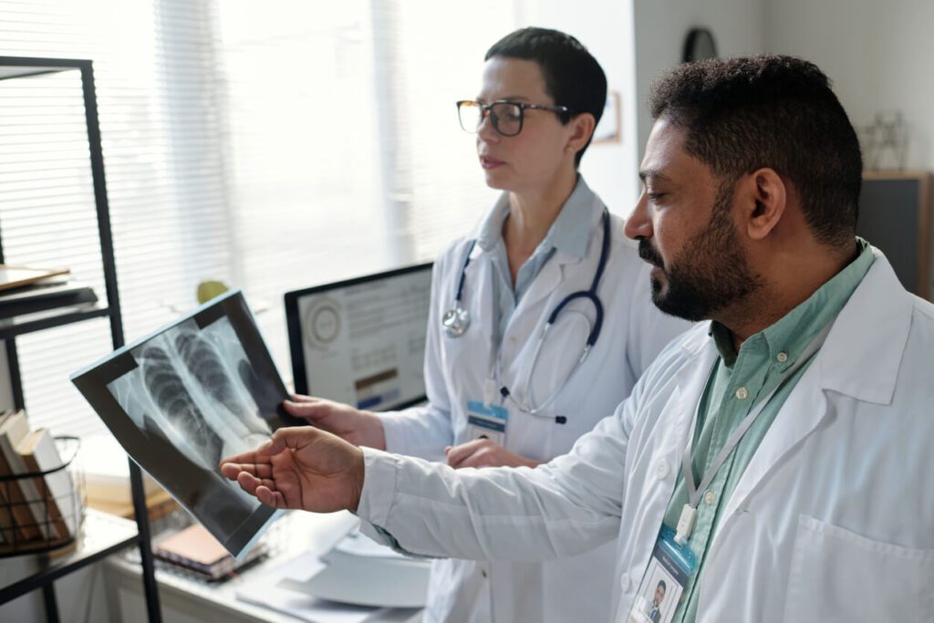 Pulmonology Doctors Discussing Patient Lung X-Ray Images.